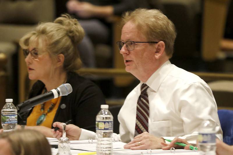 Paul Lockwood, who completed in the Scripps Nation Spelling Bee 50 years ago, reads a definition to contestant during the McHenry County Regional Office of Education 2023 Spelling Bee Wednesday, March 22, 2023, at McHenry County College's Luecht Auditorium in Crystal Lake.