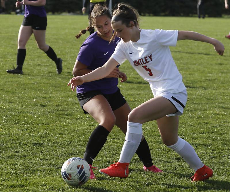 Huntley's Maizie Nickle pushes past Hampshire's Hope Lorbiecki during a Fox Valley Conference soccer game on Tuesday, April 23, 2024, at Hampshire High School.