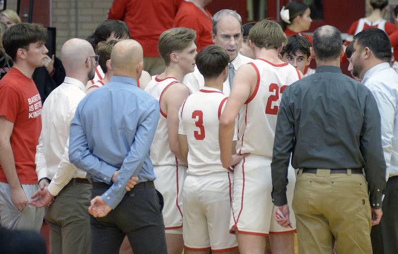 Pirate Head Coach Mark Cooper addresses the team during a time out after falling behind against Kaneland in the 1st period Friday at Ottawa
