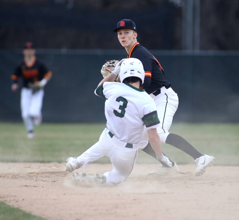 Batavia’s Nate Nazos tags Glenbard West’s Joey Campanella out at second during a game at Village Green Park in Glen Ellyn on Wednesday, March 13, 2024.