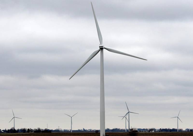 Wind turbines harvest the air currents surrounding the property owned by Steve Rosene on Tuesday in Shabbona.