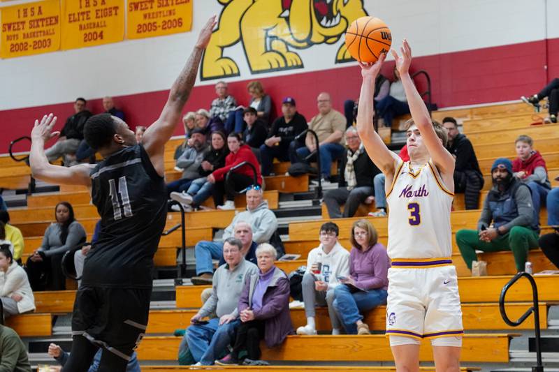 Downers Grove North's Nolan Hurter (3) shoots a three pointer against Oswego East's Reginald McWaine (11) during a Batavia Night of Hoops Basketball game at Batavia High School on Saturday, Jan. 25, 2025.
