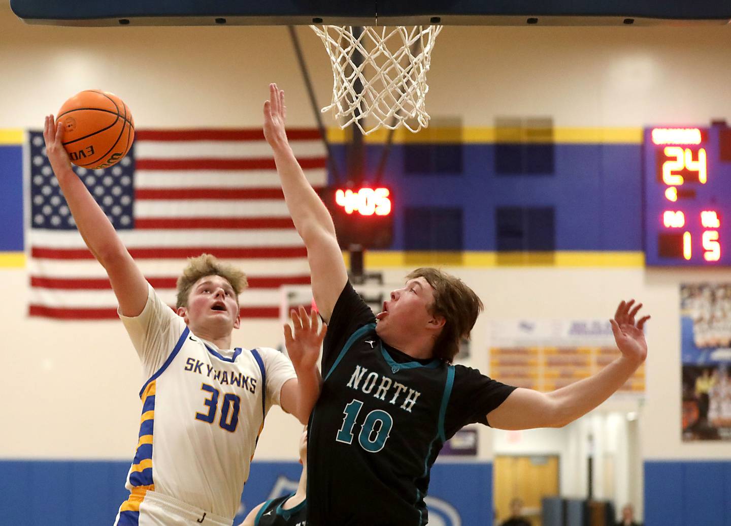 Johnsburg's Jayce Schmitt drives to the bask agains tWoodstock North's Brady Rogers during a Kishwaukee River Conference boys basketball game on Monday, Dec. 15, 2025, at Johnsburg High School.