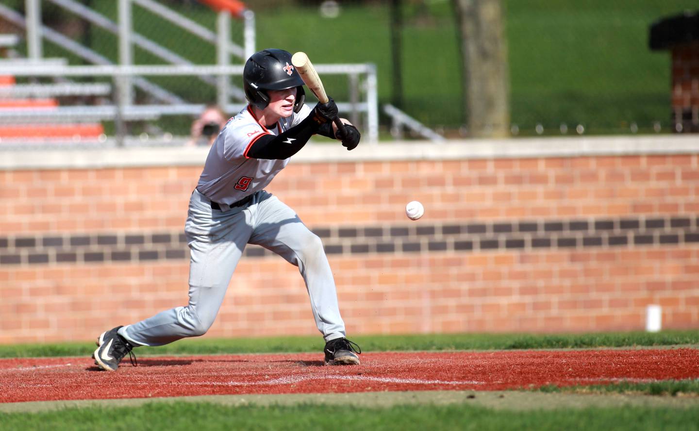 St. Charles East's Michael Aloisio bunts during a game against Wheaton North on Wednesday, April 23, 2025 in St. Charles.