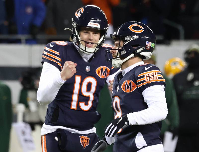 Chicago Bears holder Tory Taylor (left) and place kicker Cairo Santos celebrate after making a late extra point during their NFL Wild Card game against the Green Bay Packers Saturday, Jan. 10, 2026, at Soldier Field in Chicago.
