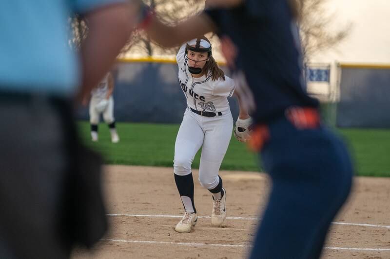 Oswego East's Nicole Stone (16) delivers a pitch against Oswego during a softball game at Oswego East High School on Wednesday, April 19, 2023.