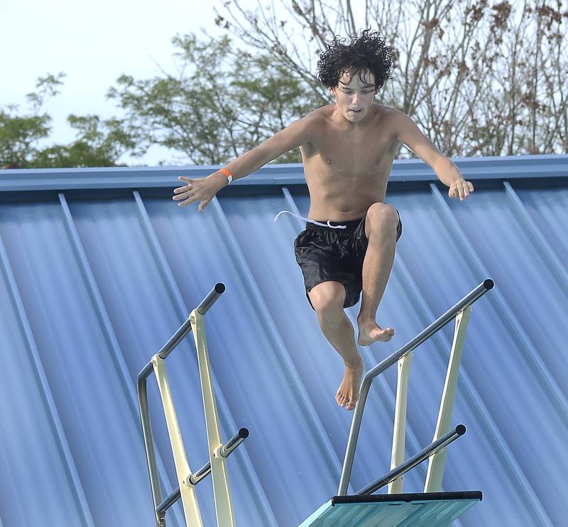 Tommy Fultz takes a giant leap of the diving board Tuesday, Aug. 1, 2023, at Ottawa’s Riordan Pool during National Night Out.