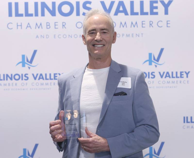 Fran Brolley poses with his Cornerstone award during the Illinois Valley Chamber of Champions of Change Awards Night on Wednesday, May 6, 2026 at the Westclox Event Center in Peru.