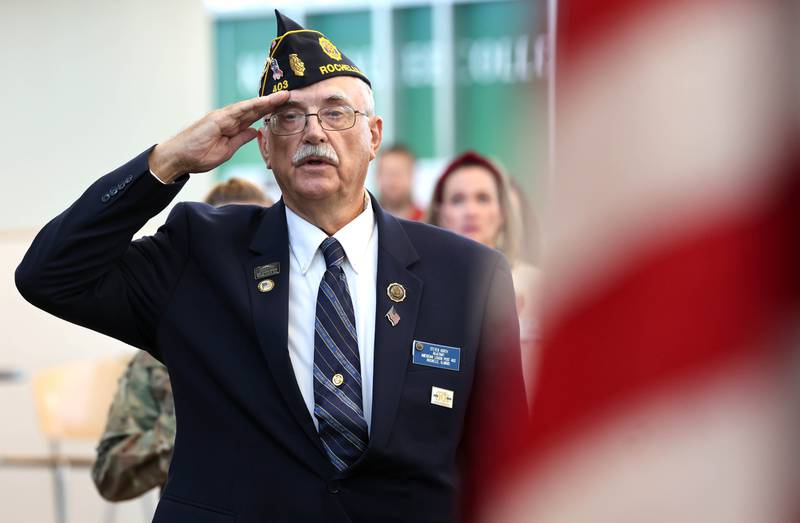 Steve Korth, a U.S. Army veteran and Kishwaukee College alumni, salutes the flag during the Pledge of Allegiance at the 2023 Veterans Day Ceremony Thursday, Nov. 9, 2023, at Kishwaukee College in Malta.