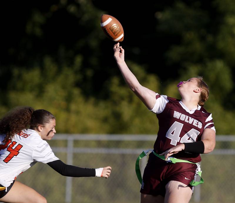 Crystal Lake Central's Elynor Raithel rushes Prairie Ridge’s Alayna Cooper-Turnage as she throw a pass during a girls flag football game on Thursday, Sept. 4, 2025, at Prairie Ridge High School in Crystal Lake.