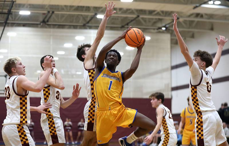 Johnsburg's Jarrel Albea splits the Richmond-Burton defense during a Kishwaukee River Conference boys basketball game on Tuesday, Jan. 27, 2026, at Richmond-Burton High School.