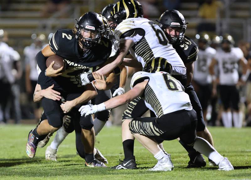 Sycamore's Elijah Meier runs into a host of Oak Forest defenders during their game Friday Sept. 2, 2022, at Sycamore High School.