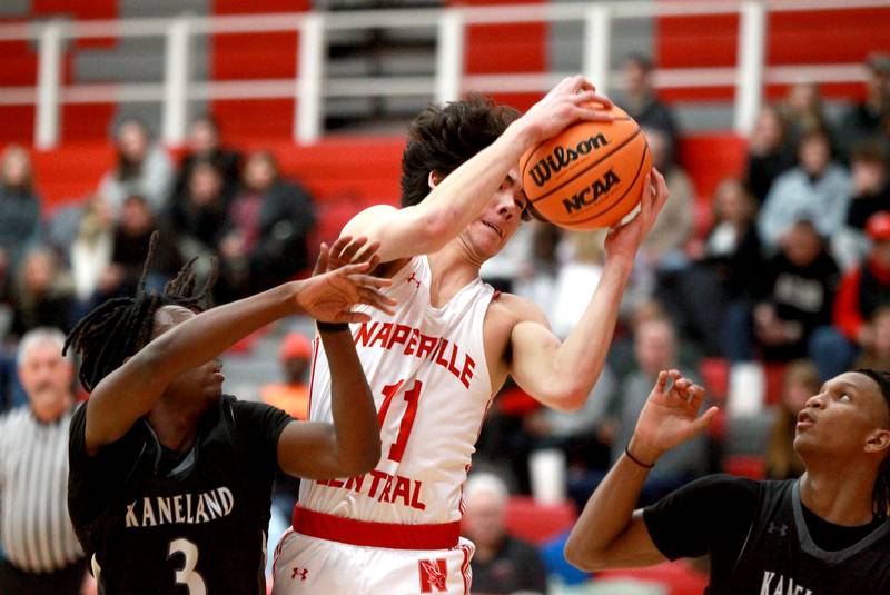 Naperville Central's Casey Cooperkawa graps a rebound during a game against Kaneland on Tuesday, Jan. 14, 2025 in Naperville.