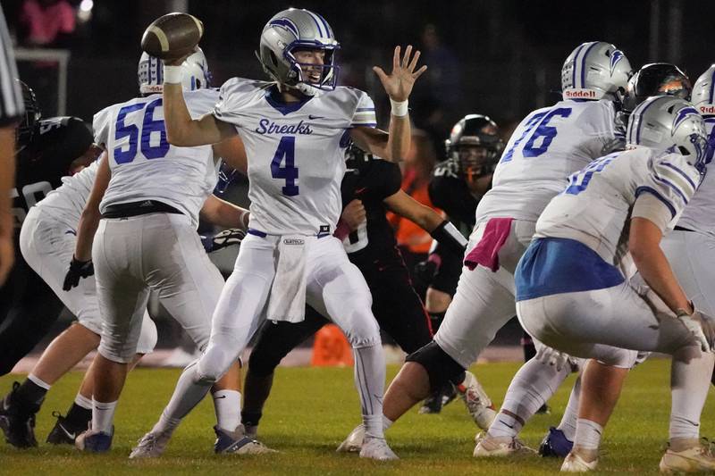 Woodstock's Caden Thompson (4) throws a pass against Sandwich during a football game at Sandwich High School on Friday, Oct. 11, 2024.