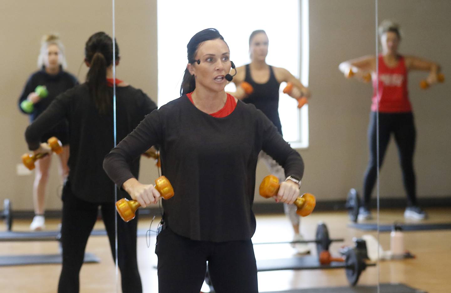 Becky Moore, a fitness coordinator at the McHenry Recreation Center, leads a Les Mills Body Pump and Core class Thursday, Dec. 22, 2022, at the center in McHenry.