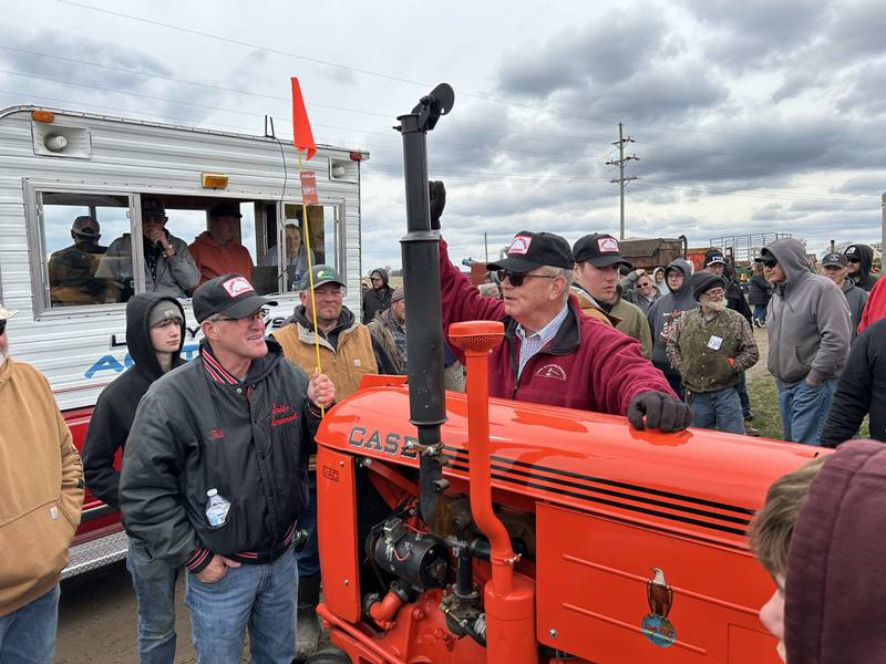 Auctioneer Lenny Bryson takes a bid on a 1949 Case tractor at the Hazelhurst Spring Sale on  Saturday, April 5, 2025. The tractor was restored by Forreston FFA members. Dave Myers, of Leaf River Farms in Adeline, won the tractor in a raffle and put the tractor on the auction block, donating all the proceeds back to the Forreston FFA.