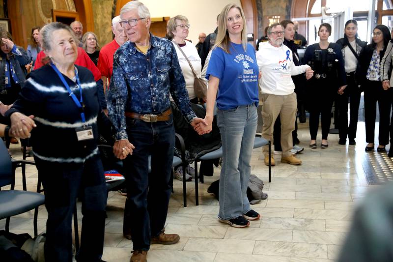 Participants join hands during the annual Hands Around the Courthouse in honor of National Child Abuse Prevention Month on Thursday, April 10, 2025 at the Kane County Courthouse in Geneva.