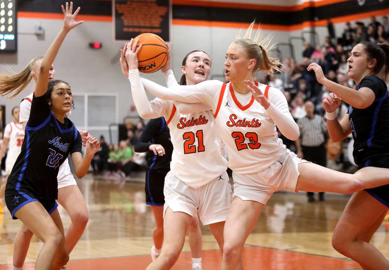 St. Charles East's Sofia O’sullivan (left) and Alyse Price (right) go after the rebound during a game against St. Charles North on Friday, Jan. 31, 2025 at St. Charles East.