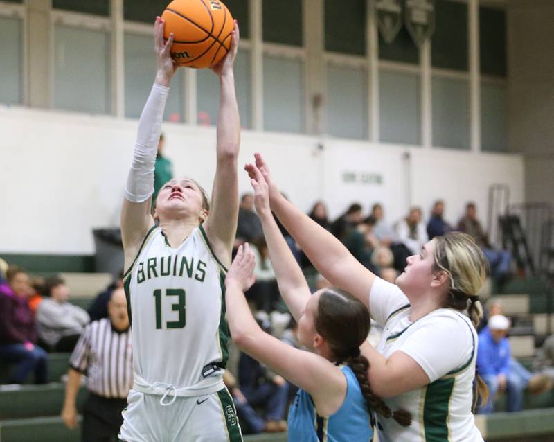 St. Bede's Ashlyn Ehm reaches up to grab a rebound over Marquette's Hunter Hopkins on Monday, Dec. 2, 2024 at St. Bede Academy.