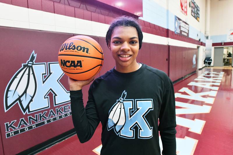 Kankakee senior TaLeah Turner holds a basketball courtside ahead of her senior night game at Kankakee High School. Turner masters life and the game with the help of her cochlear implants.