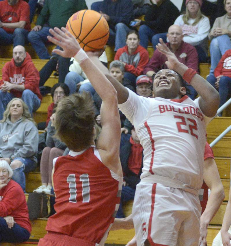 Streator’s Tristan Finley works to get this layup past Morton’s Owen Adams in the 2nd period Wednesday at Streator.