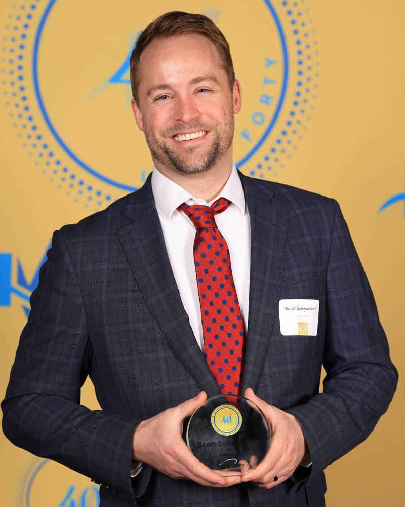 Scott Schweickert poses with his 40 Under Forty award during the Illinois Valley Chamber of Commerce Champions of Change Awards Night on Thursday, April 10, 2025 at the Westclox Event Center in Peru.