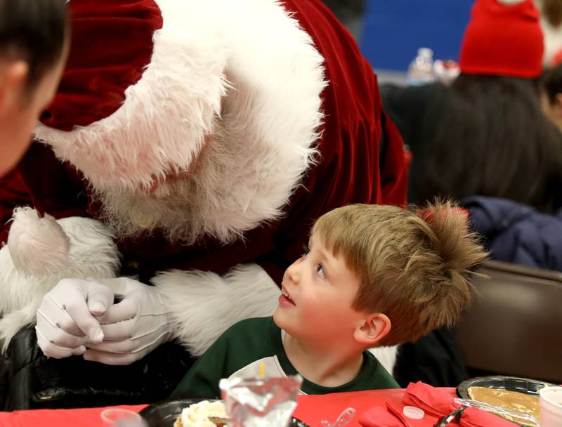 David Brown, 4, of St. Charles talks to Santa Claus during a Breakfast with Santa hosted by the St. Charles Park District at the Pottawatomie Community Center on Monday, Dec. 12, 2022.