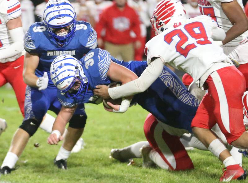 Princeton's Common Green lunges for a few extra yards with the help of teammate Arthur Burden as Oregon's Jayden Berry looks to make the tackle during the Class 3A playoff game on Friday, Nov. 1, 2024 at Princeton High School.
