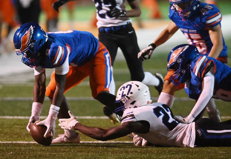 Hoffman Estates’ Jaime Wisdon, left, recovers a kickoff fumbled by Maine East that Samuel Oppong can’t quite reach during Friday’s football game in Hoffman Estates.