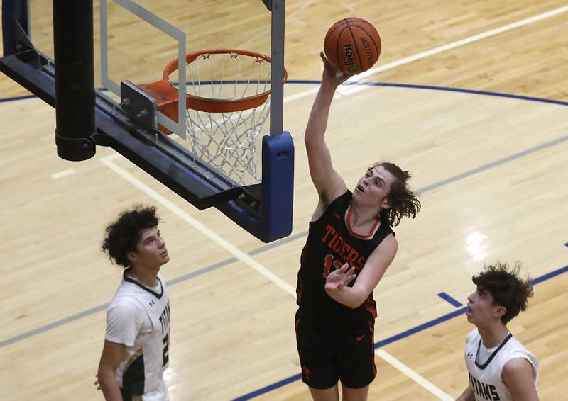 Crystal Lake Central's Jake Terlecki drives to the basket between Boylan’s Santana English and Aedan Campos during a IHSA Class 3A boys basketball regional boys basketball game Thursday, Feb. 23, 2023, at Woodstock High School.
