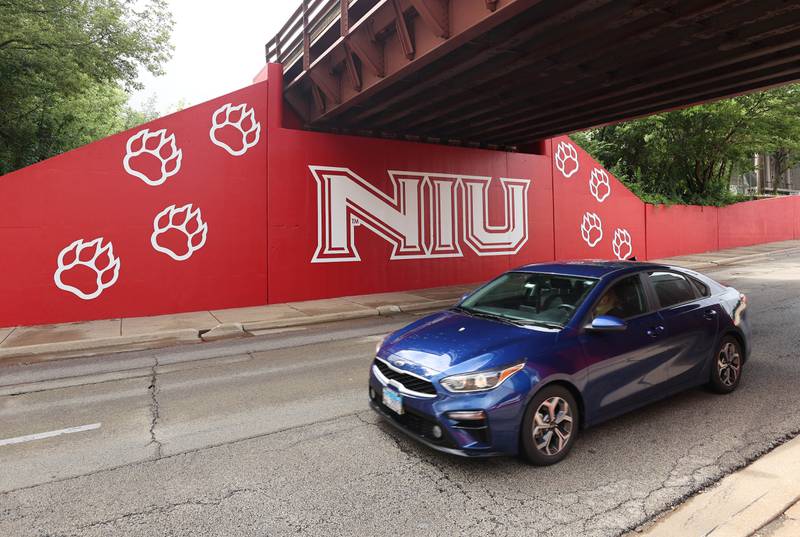 A car drives by part of the new Huskie mural Monday, Aug. 14, 2023, on the Annie Glidden Road railroad underpass, just south of Lincoln Highway in DeKalb. The mural was a joint project between the City of Dekalb and Northern Illinois University.