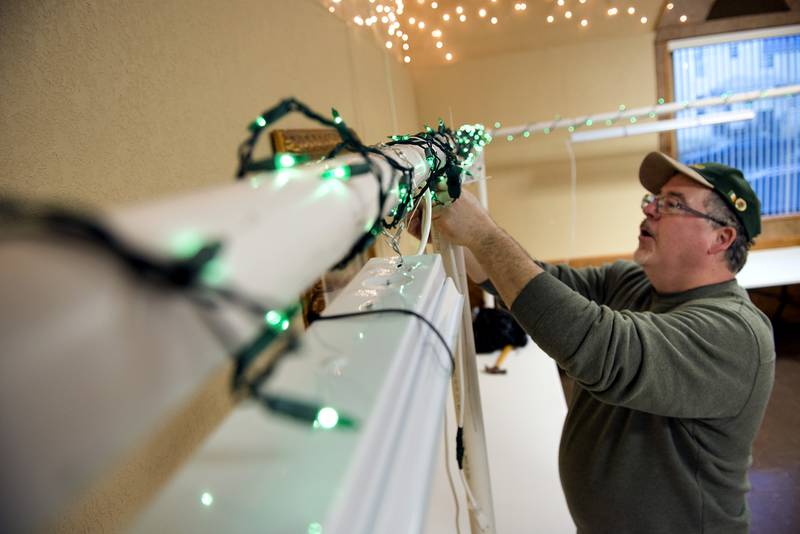 2019 File: Phil Lahey, a member of the Rock River Valley Shamrock Club, hangs lights in preparation for the club's St. Patrick's parade.