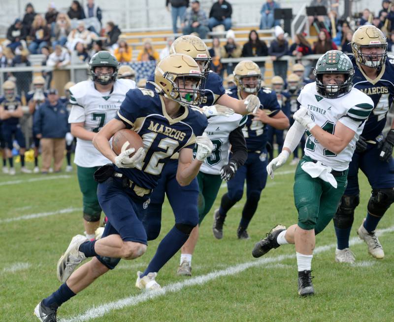 Polo's Billy Lowry (12) runs for yards against West Carroll during 8-man football playoff action on Saturday, Nov. 9, 2024 at Polo High School.