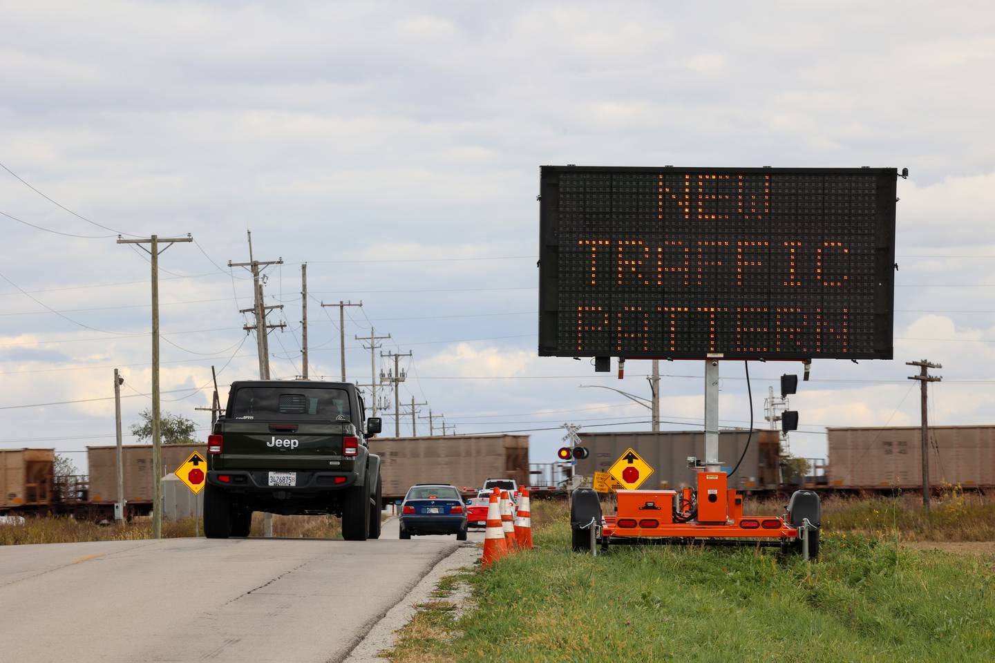 A sign informs drivers of a traffic pattern change as they travel east on County Line Road toward the intersection at IL Route 50 on Tuesday, Oct. 21, 2025. Crews were at work that day preparing for the creation of a four-way stop at the accident-prone intersection where 18 accidents and four fatalities have occurred this year.