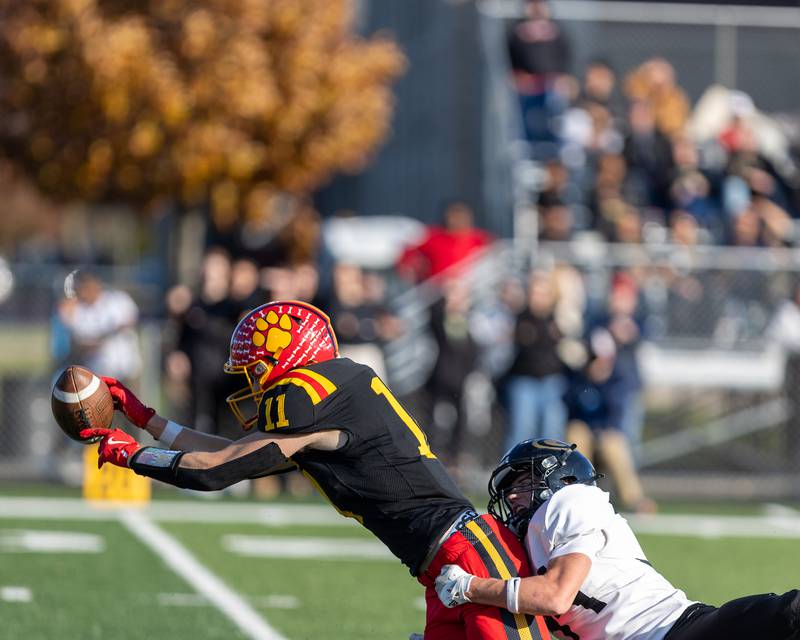 Batavia's Brett Berggren tries to make the catch as Glenbard North's Marco Rafael with the tackle at the Class 7A Quarter Final on Saturday, Nov.15,2025 in Batavia.