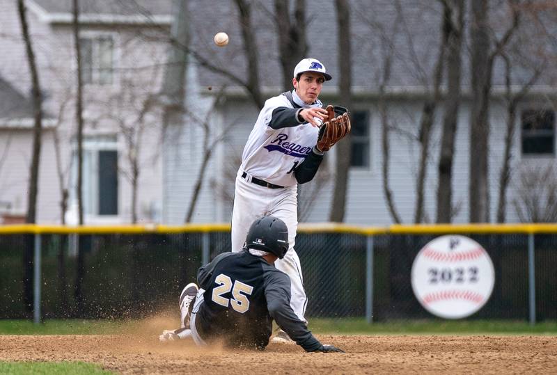 Plano’s Christian Sloat (14) throws to first to turn the double play against Sycamore during a baseball game at Plano High School on Monday, April 4, 2022.