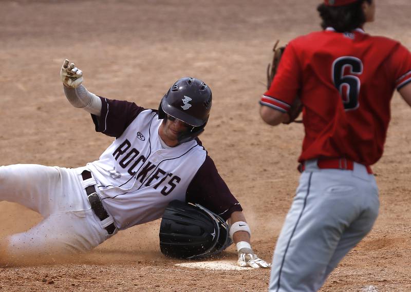 Richmon-Burton’s Connor Wallace slides into home plate during a IHSA Class 2A supersectional baseball game between Richmond-Burton and Timothy Christian at the Rockford Rivets Stadium in Rockford.