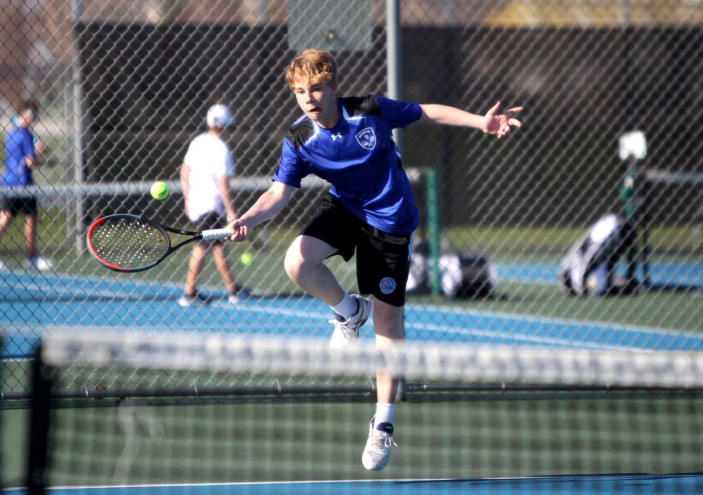 Geneva’s Tyler Masoncup returns the ball during a number one doubles match against St. Charles North with partner Ryan Cedergren (not pictured) on Thursday, April 21, 2022. Tyler, a freshman, is the son of St. Charles North Head Coach Sean Masoncup.