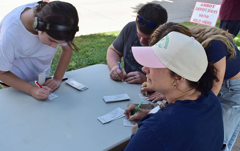 Makayla (left), Scott, Lily, and Christine of the Bass family from Dixon enter their names into Amboy's Depot Days 50/50 raffle on Sunday, Aug. 24, 2025.