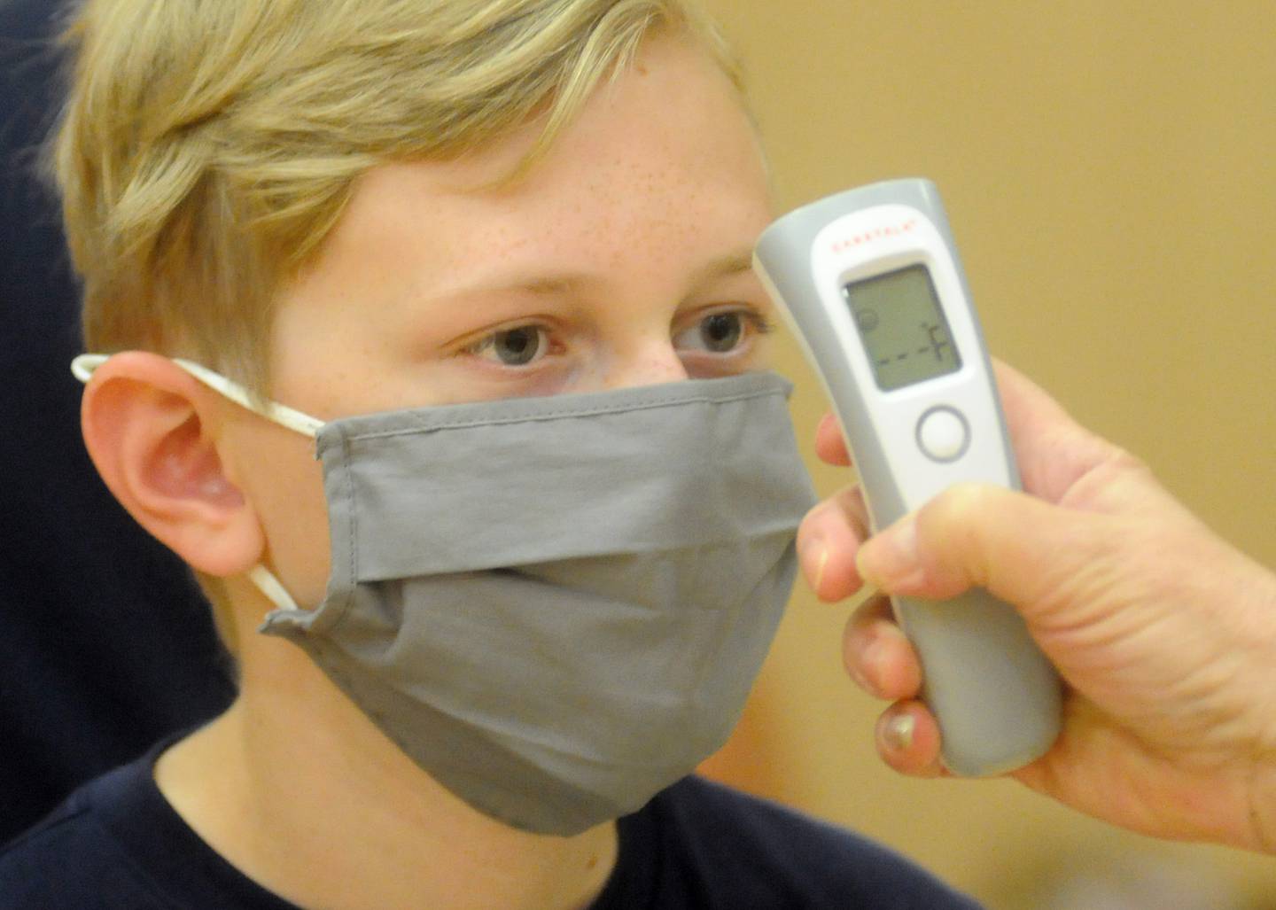 Trevor Robertson, 12, of Huntley, as his temperature checked Saturday morning, July 31, 2021, before receiving a dose of the Pfizer Covid Vaccine during a Walgreen’s Vaccination Clinic at Huntley High School.