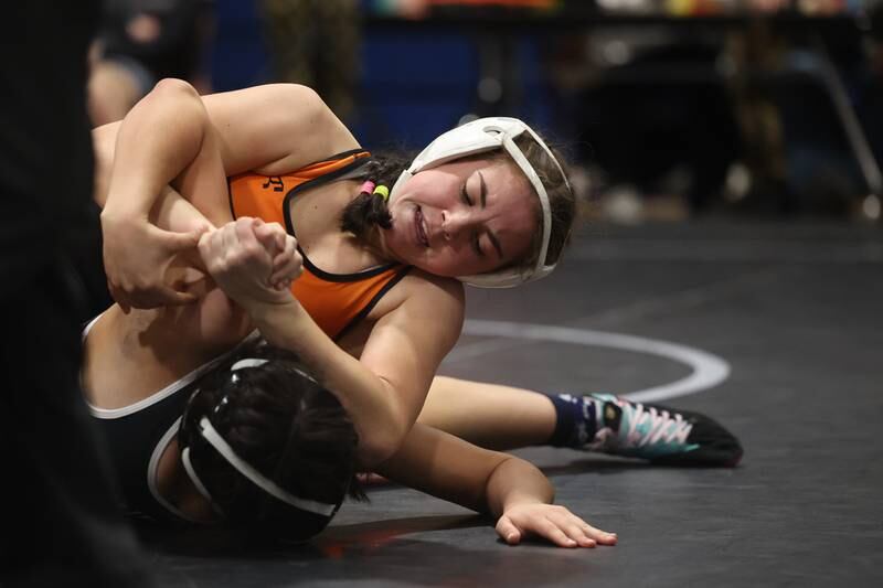 Minooka’s Addison Cailteux works over Joliet Township’s Alexandra Rosas in the Southwest Prairie Conference 130 pound Championship at Joliet Central on Saturday, Jan. 20th, 2024.