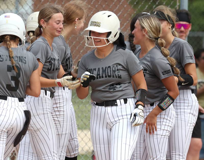 Sycos’ Jasmine Rodriguez center is welcomed at the plate after homering Friday, June 27, 2025, during their 16u game against Select Fastpitch in the Storm Days tournament at the Sycamore Community Sports Complex.