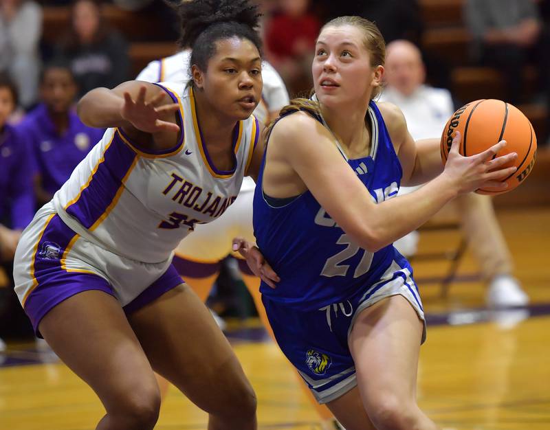 Lyons Township's Gwen Smith drives to the basket as Downers Grove North's Elizabeth Murphy defends during a game on December 11, 2024 at Downers Grove North High School in Downers Grove.