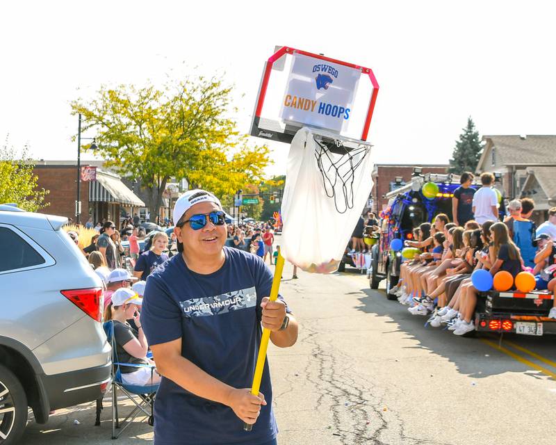 Paul Villanueva of Oswego gets ready to catch candy in his Oswego candy hoops during Oswego High School’s homecoming parade on Sunday Sept. 15, 2024, that traveled through downtown Oswego.