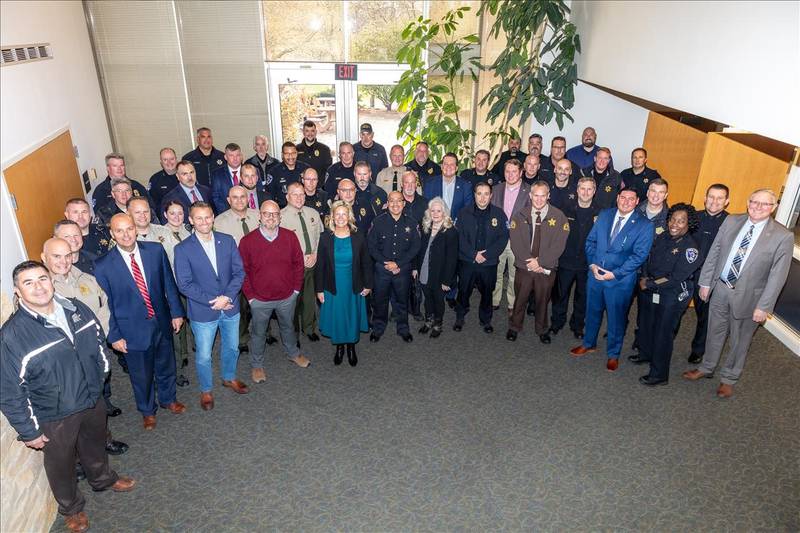 State Rep. Tony McCombie (center) recently met with area law enforcement leaders and state legislators.