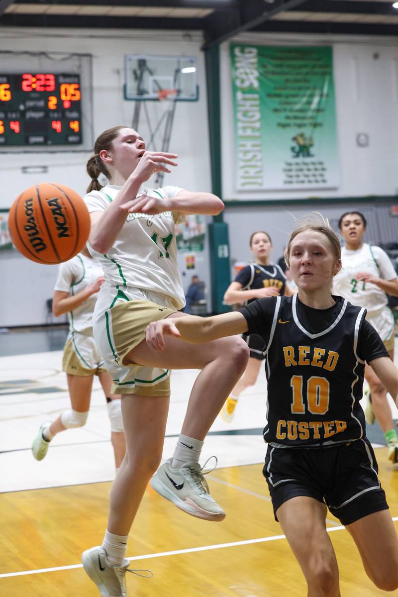 Reed-Custer's Kamryn Wilkey knocks the ball away from Bishop McNamara's Maggie Manes during Bishop McNamara's 60-36 victory over Reed-Custer in the IHSA Class 2A Bishop McNamara Regional semifinals on Monday, Feb. 16, 2026.