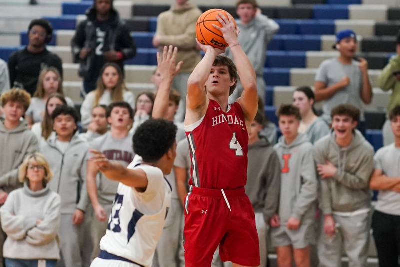 Hinsdale Central's Vincas Buzelis (4) shoots a three pointer against Oswego East during a hoops for healing tournament basketball game at Oswego East High School on Tuesday, Nov. 26, 2024.