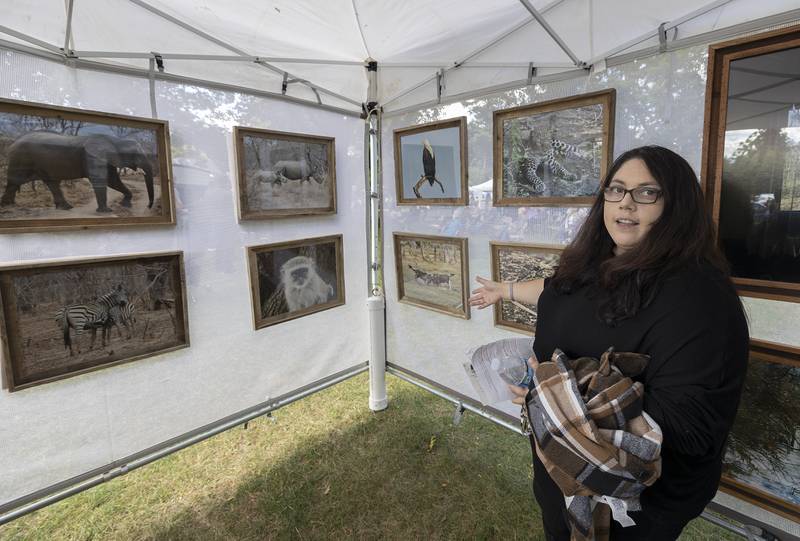 Grand Detour Arts Festival judge Danielle Koenig talks about the work of David Bingaman Sunday, Sept. 7, 2025. Bingaman was awarded an honorable mention for his wildlife photography.