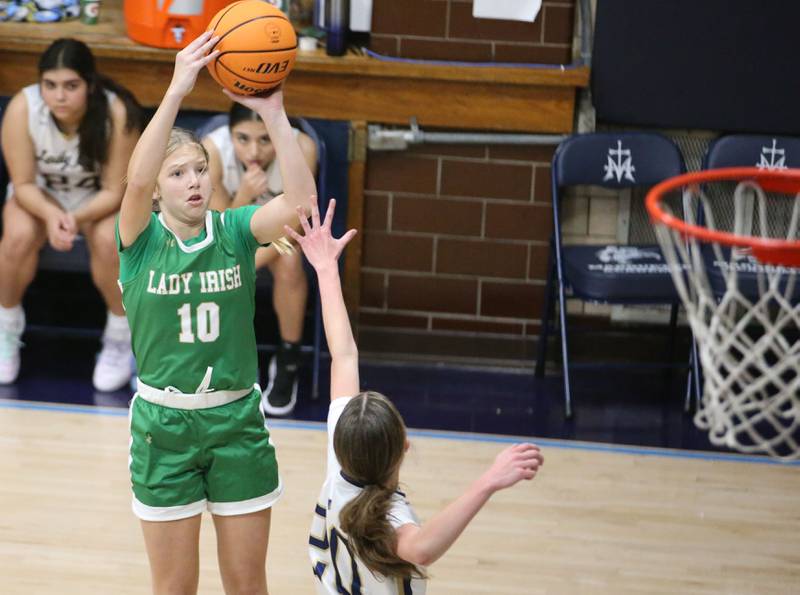 Seneca's Graysen Provance shoots a jump shot over Marquette's Kaitlyn Davis on Thursday, Dec. 5, 2024 in Bader Gym at Marquette High School.