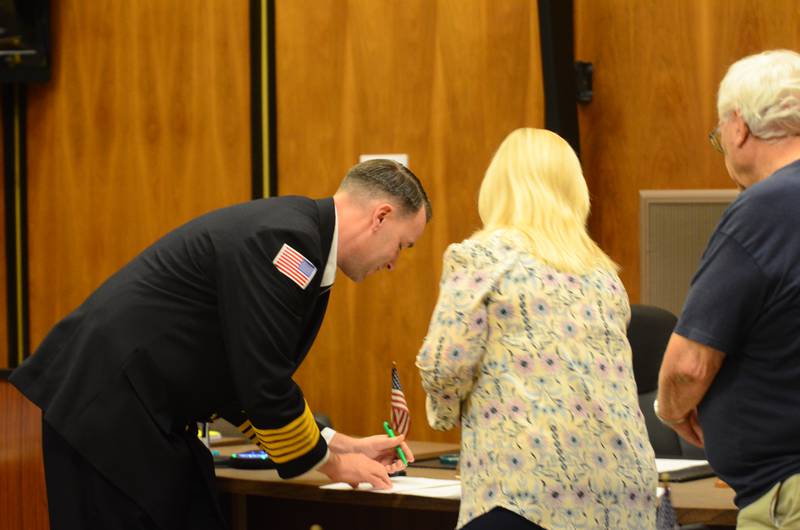 Former Rock Falls Deputy Fire Chief Kyle Sommers (left) takes the oath of office for his new role as department chief Tuesday, Jan. 20, at the Rock Falls City Council meeting.